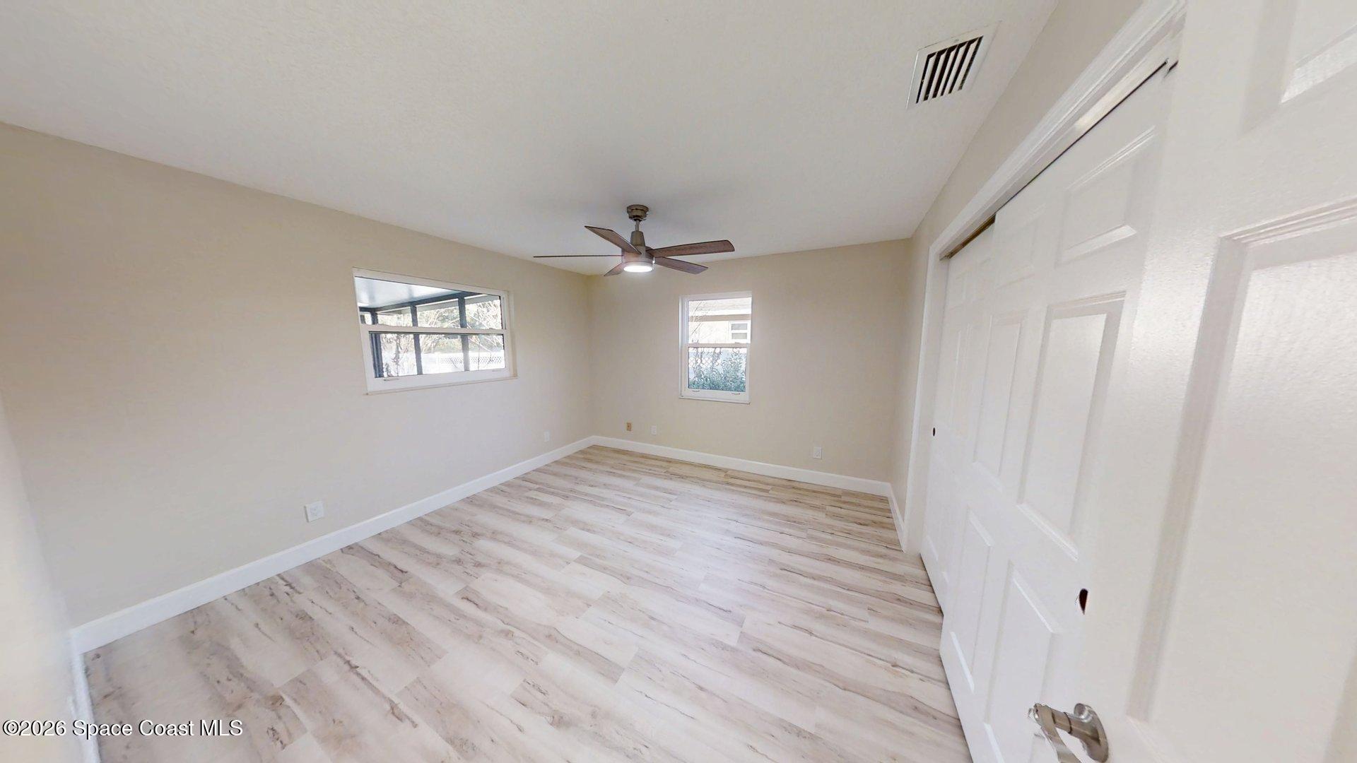 137 Concha Drive Sebastian, FL 32958 - Photo 19 of 29 a view of empty room with wooden floor and fan