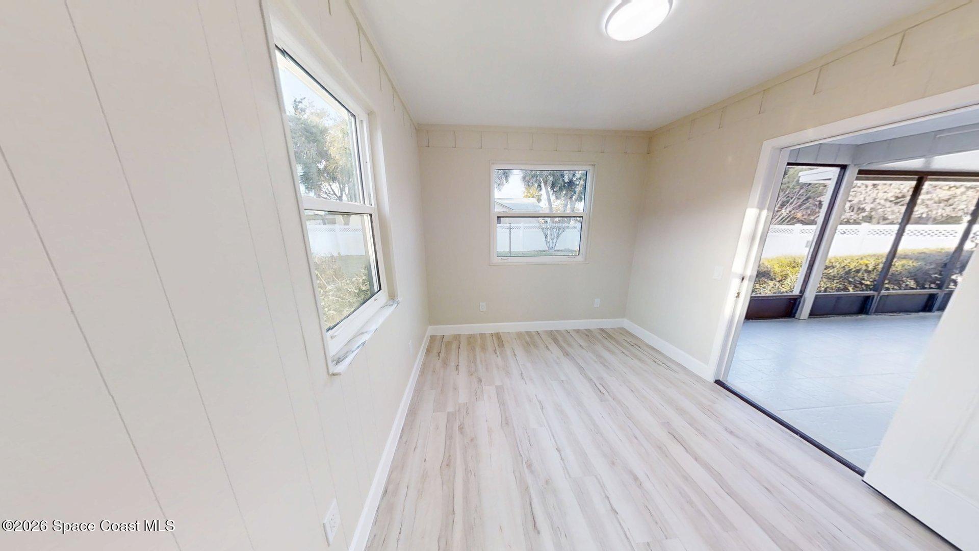 137 Concha Drive Sebastian, FL 32958 - Photo 21 of 29 a view of an empty room with wooden floor and a window
