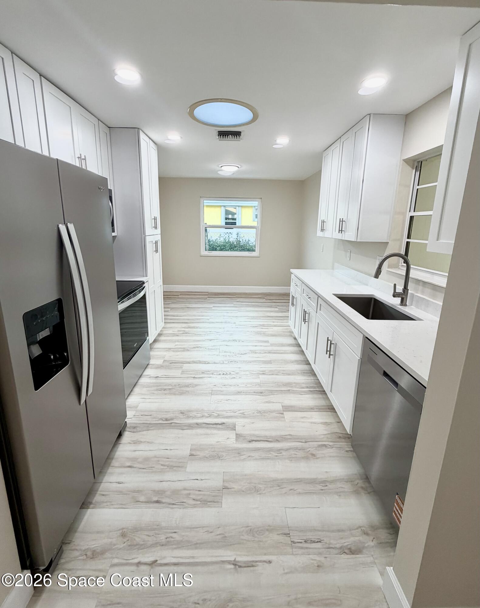 137 Concha Drive Sebastian, FL 32958 - Photo 8 of 29 a kitchen with stainless steel appliances granite countertop a refrigerator and a sink
