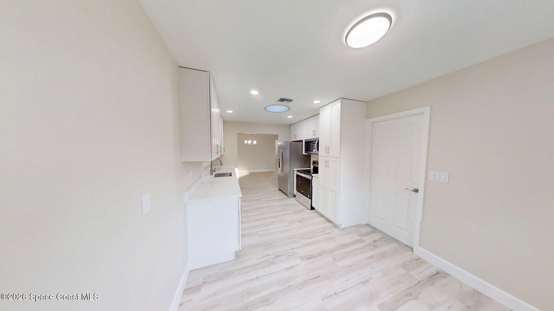 137 Concha Drive Sebastian, FL 32958 - Photo 10 of 29 a view of a kitchen with wooden floor