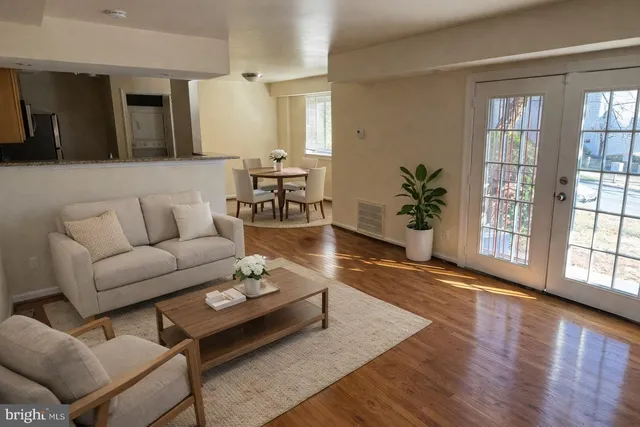 a living room with furniture and wooden floor