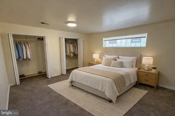 a bedroom with a bed and cabinets