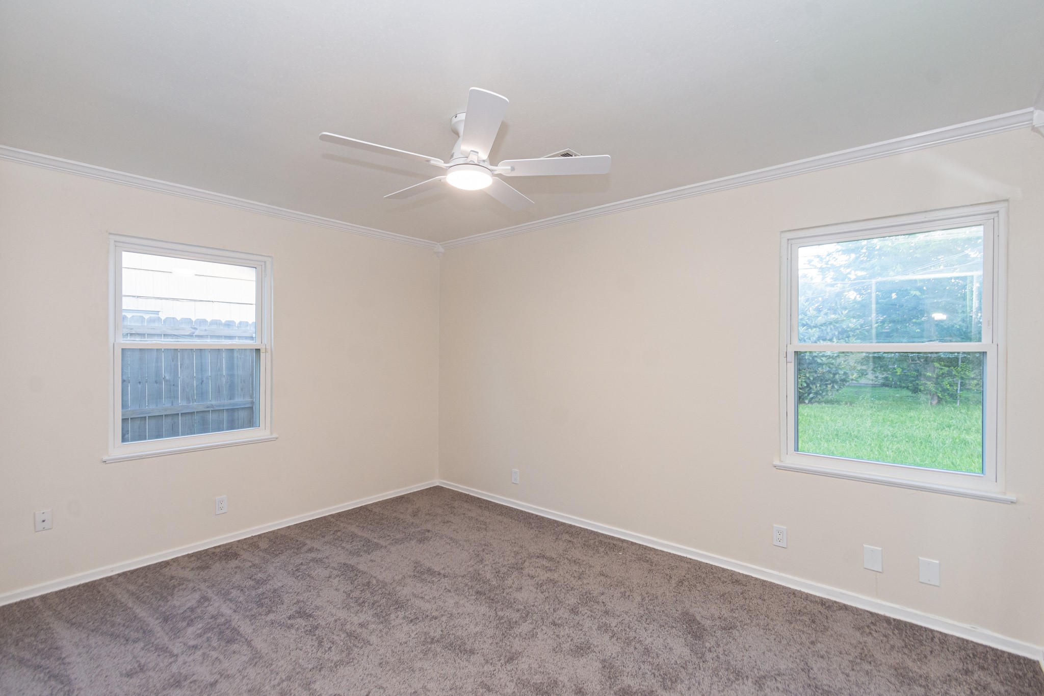 5834 Overdale Street Houston, TX 77033 - Photo 12 of 18 an empty room with a window and a fan