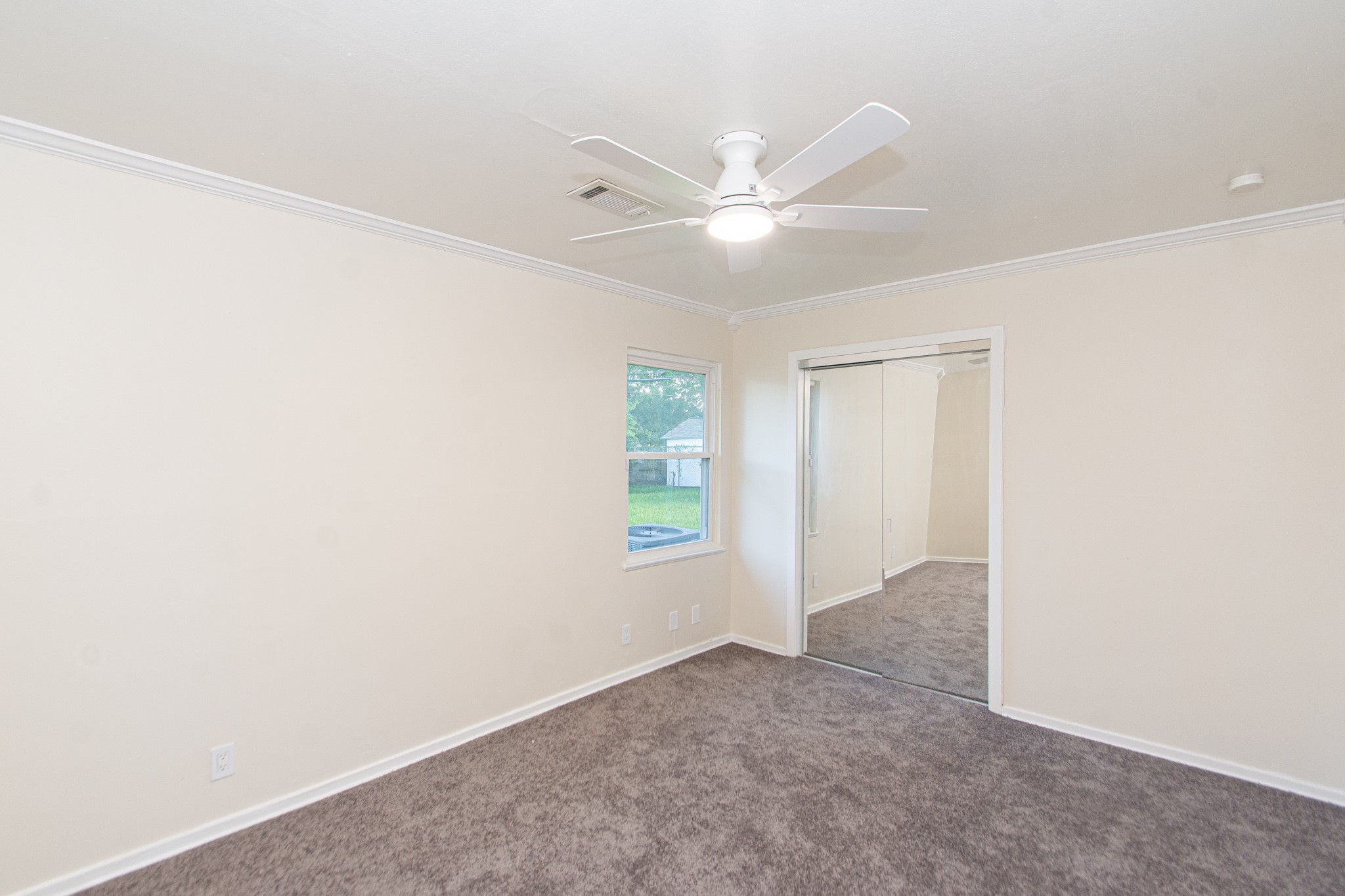 5834 Overdale Street Houston, TX 77033 - Photo 14 of 18 an empty room with windows and fan