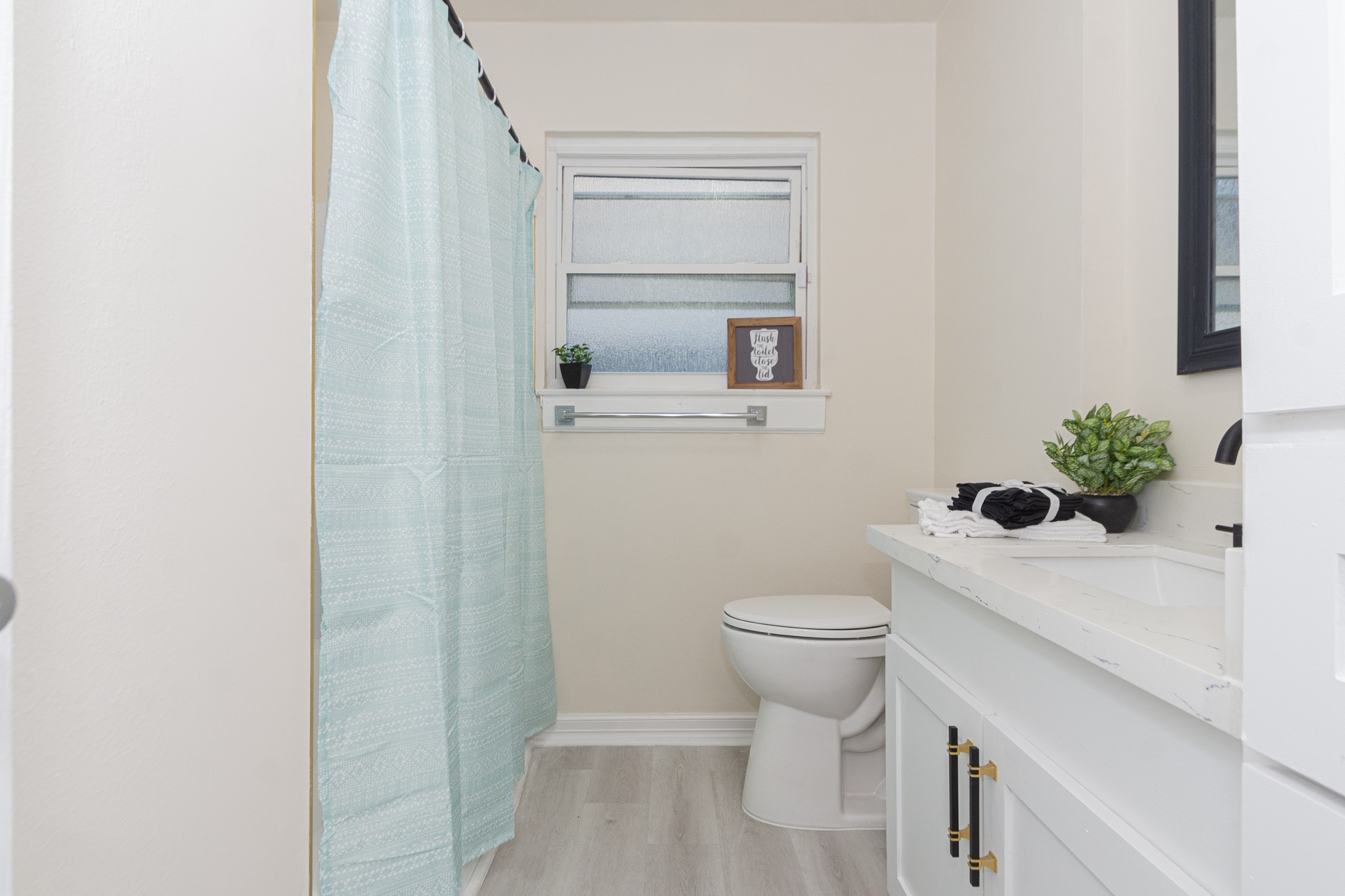 5834 Overdale Street Houston, TX 77033 - Photo 17 of 18 a bathroom with a sink a toilet and vanity