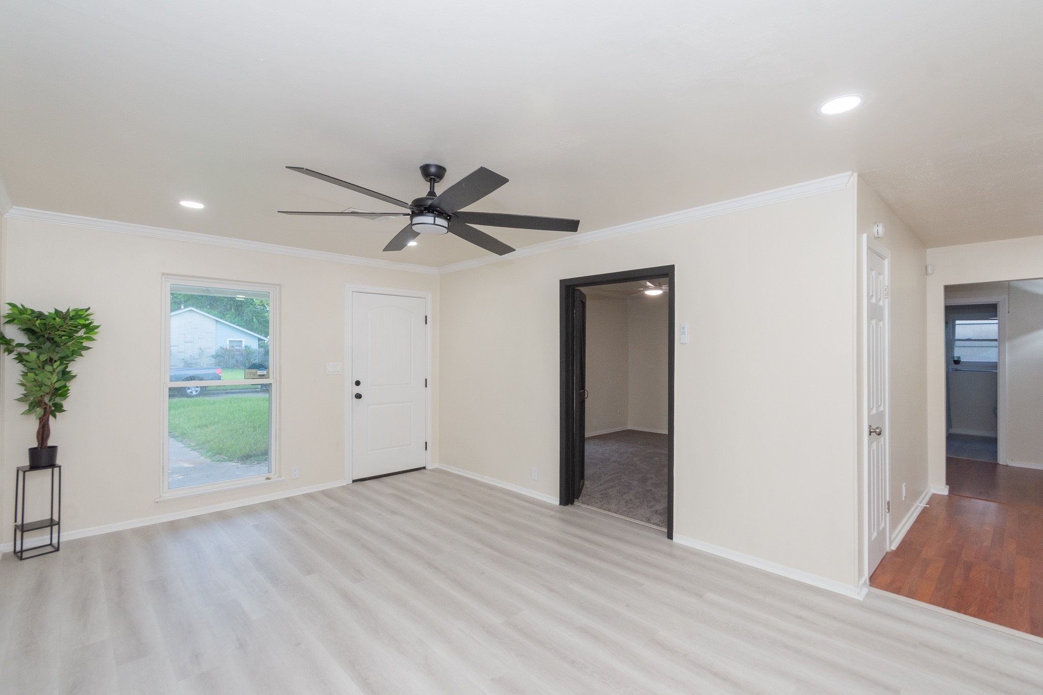 5834 Overdale Street Houston, TX 77033 - Photo 4 of 18 a view of a livingroom with a ceiling fan & entryway