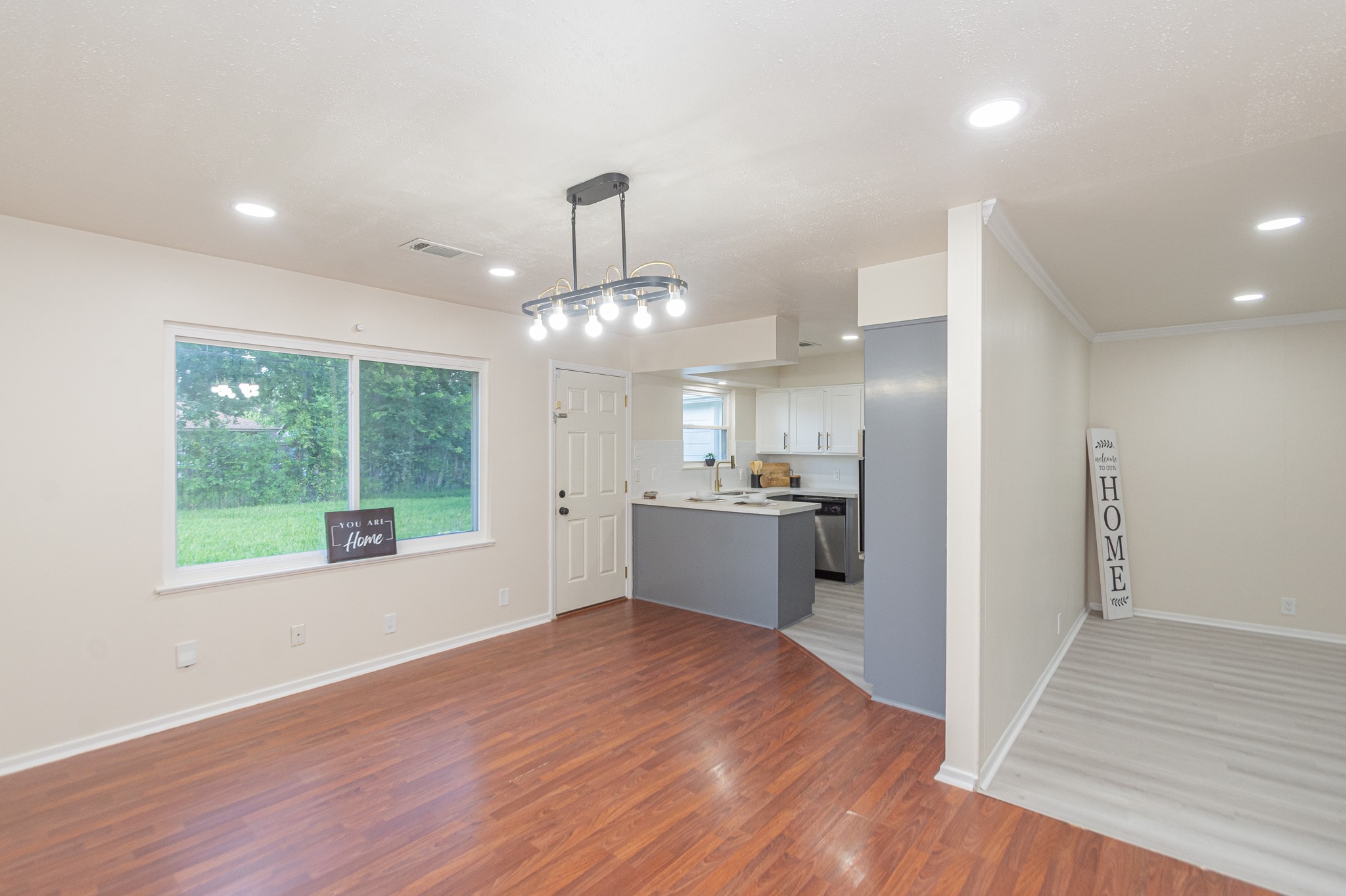 5834 Overdale Street Houston, TX 77033 - Photo 5 of 18 a open kitchen with stainless steel appliances granite countertop a refrigerator a sink dishwasher a stove and white countertops with wooden floor