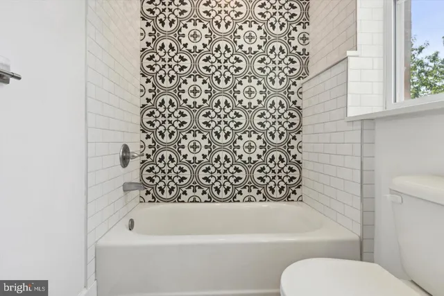 a bathroom with a toilet and a bathtub