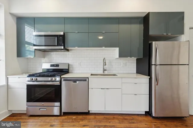 a kitchen with a stove and a refrigerator