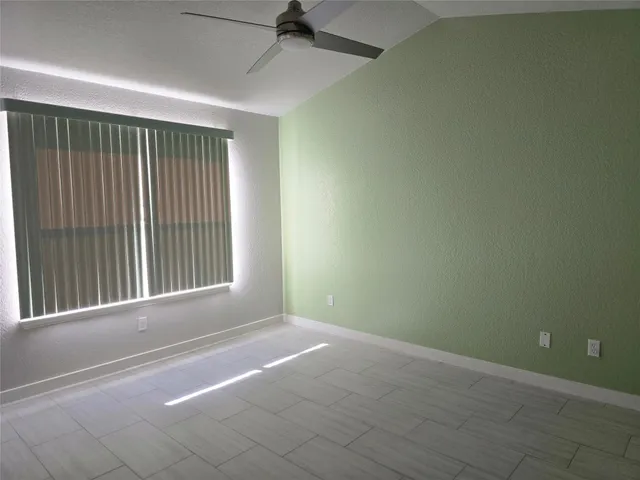 an empty room with a empty space and windows