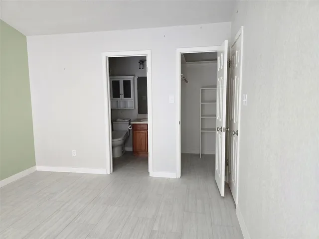 an empty room with a bathroom and a sink