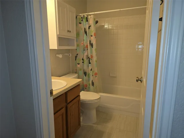 a bathroom with a shower and a toilet