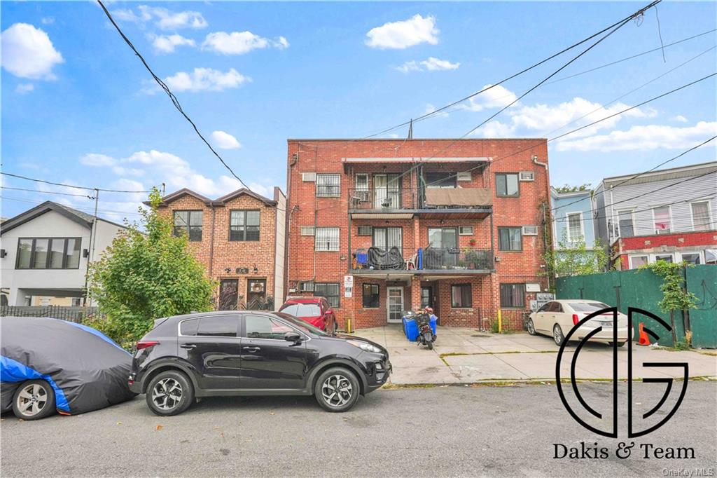 11-46 Welling Court Queens, NY 11102 - Photo 4 of 9 a car parked in front of a building