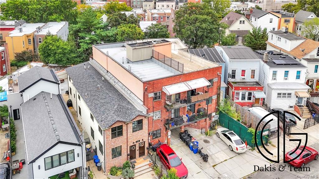 11-46 Welling Court Queens, NY 11102 - Photo 7 of 9 an aerial view of residential houses with outdoor space