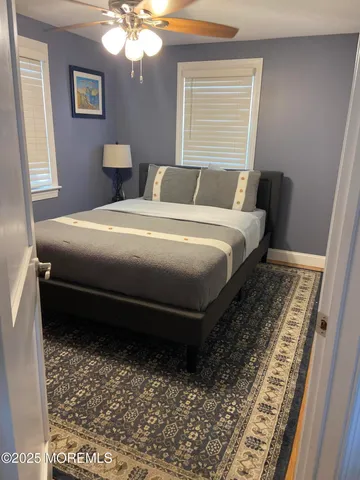 a bedroom with a bed dresser and a window