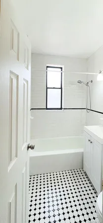 a bathroom with a bathtub and shower