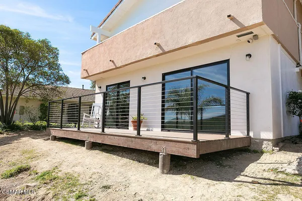 a view of a house with a wooden deck