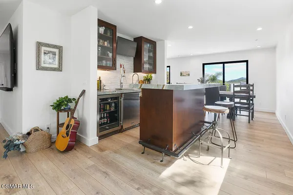 a view of a livingroom with furniture and a kitchen