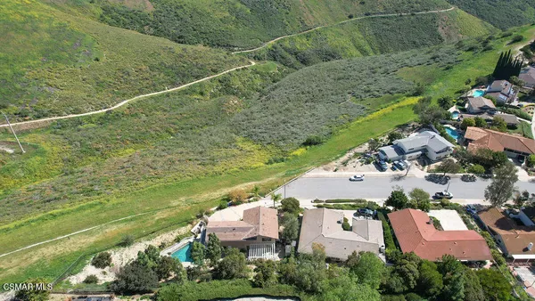 an aerial view of residential houses with outdoor space