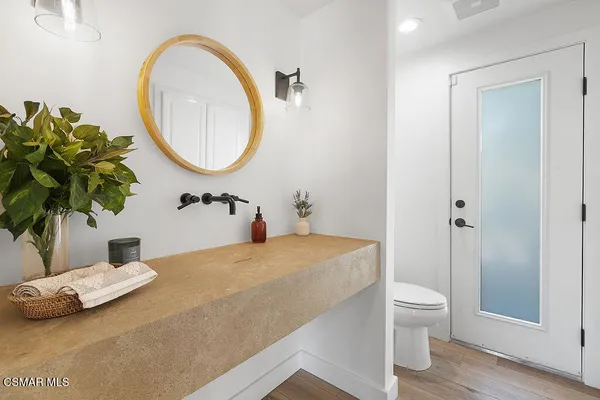 a bathroom with a sink a toilet and a mirror