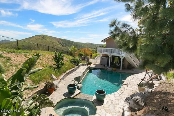 a front view of a house with a yard table and chairs