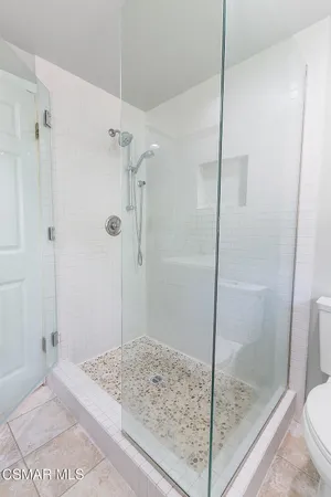 a bedroom with a large bed and a large window