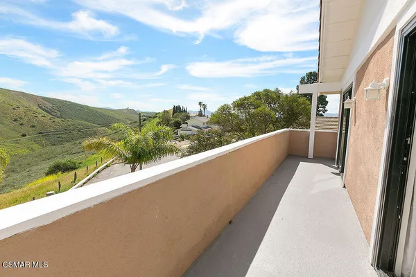a bed sitting in a bedroom next to a lamp