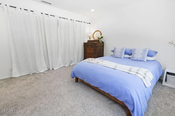 a view of a patio with table and chairs under an umbrella