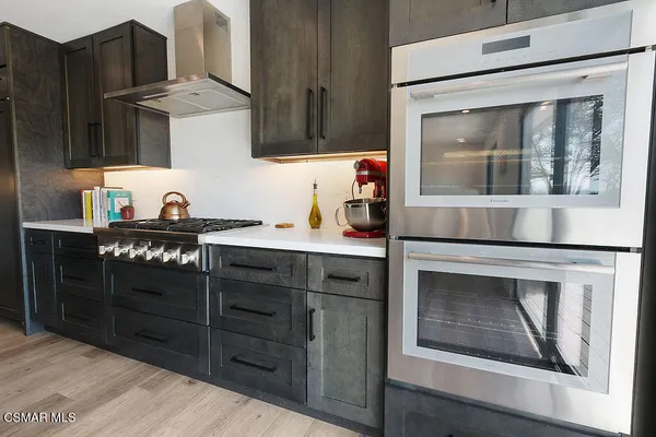 a kitchen with stainless steel appliances granite countertop a stove and a microwave