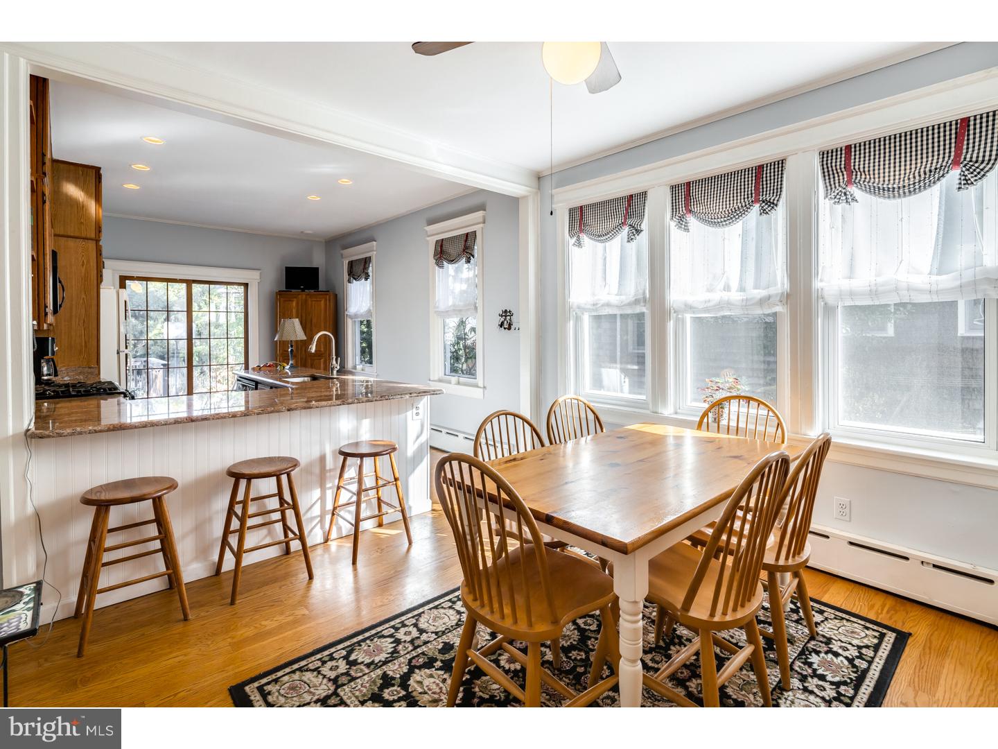 127 Lafayette Avenue Haddonfield, NJ 08033 - Photo 12 of 25 a dining room with wooden floor a glass table and chairs