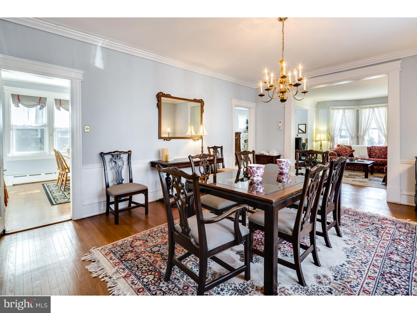 127 Lafayette Avenue Haddonfield, NJ 08033 - Photo 8 of 25 a view of a dining room and livingroom with furniture wooden floor a chandelier and a painting