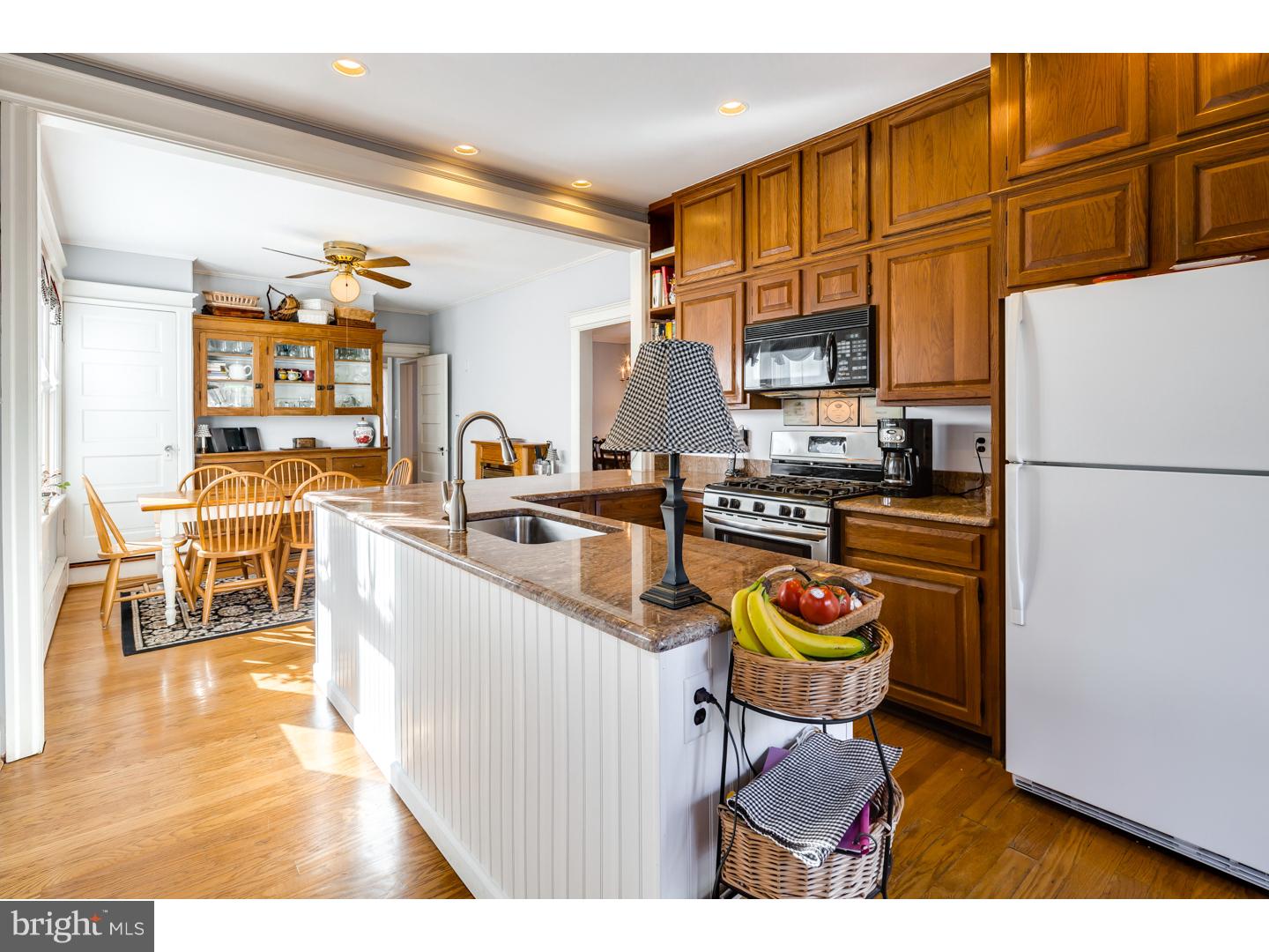 127 Lafayette Avenue Haddonfield, NJ 08033 - Photo 9 of 25 a kitchen with stainless steel appliances granite countertop a refrigerator a stove and a wooden cabinets