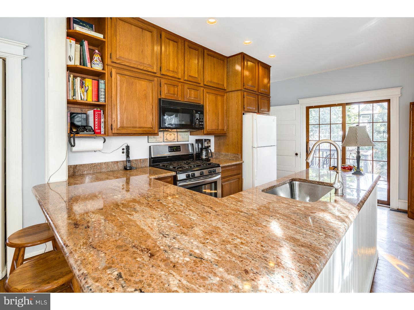 127 Lafayette Avenue Haddonfield, NJ 08033 - Photo 10 of 25 a living room with stainless steel appliances furniture a flat screen tv and a kitchen view