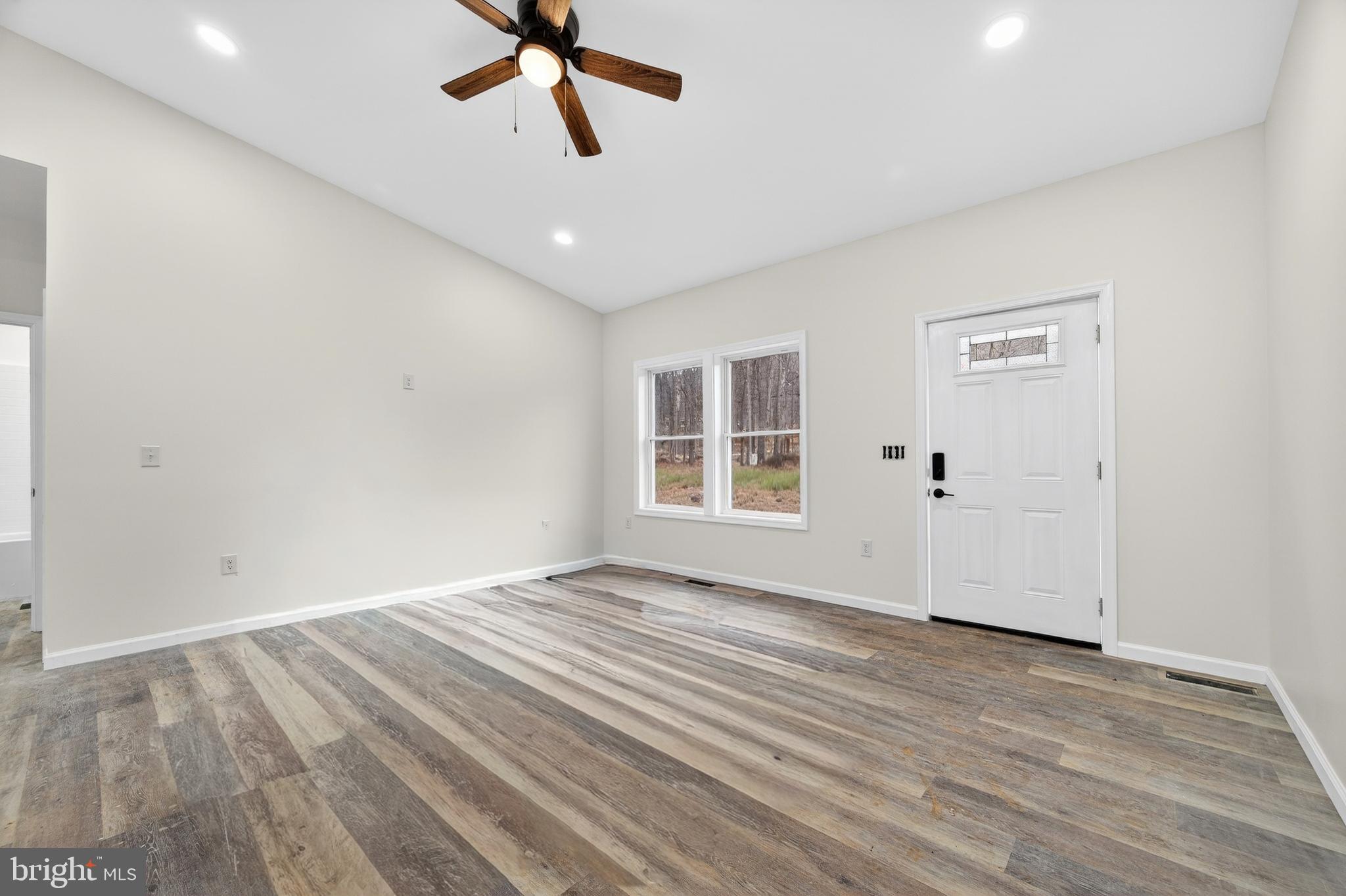 875 Buffalo Rdg Road Augusta, WV 26704 - Photo 11 of 27 a view of empty room with wooden floor and ceiling fan