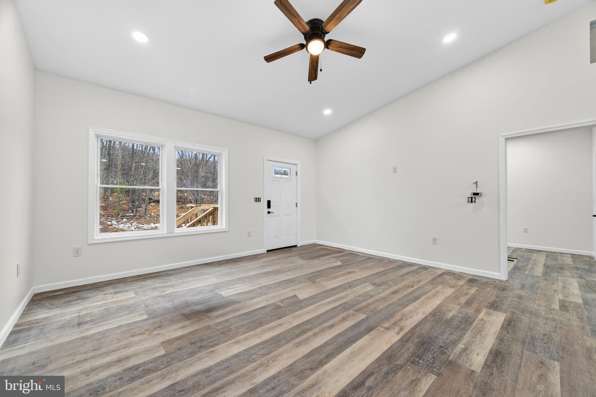875 Buffalo Rdg Road Augusta, WV 26704 - Photo 12 of 27 an empty room with wooden floor and windows