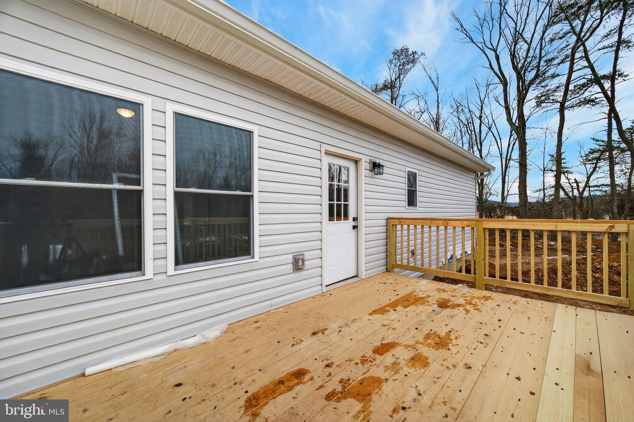 875 Buffalo Rdg Road Augusta, WV 26704 - Photo 24 of 27 a view of a balcony with a floor to ceiling window and wooden fence