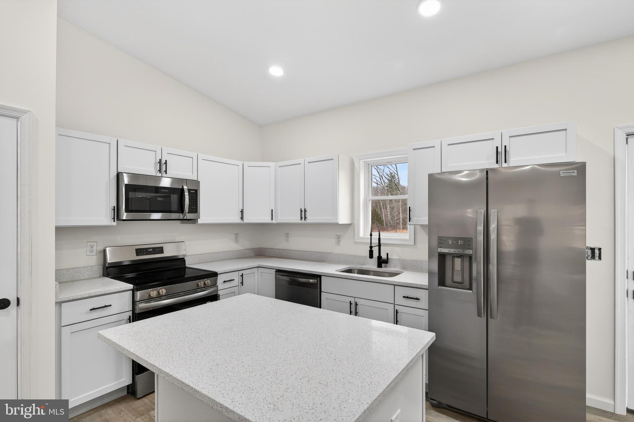 875 Buffalo Rdg Road Augusta, WV 26704 - Photo 3 of 27 a kitchen with a refrigerator a stove a microwave a sink and cabinets