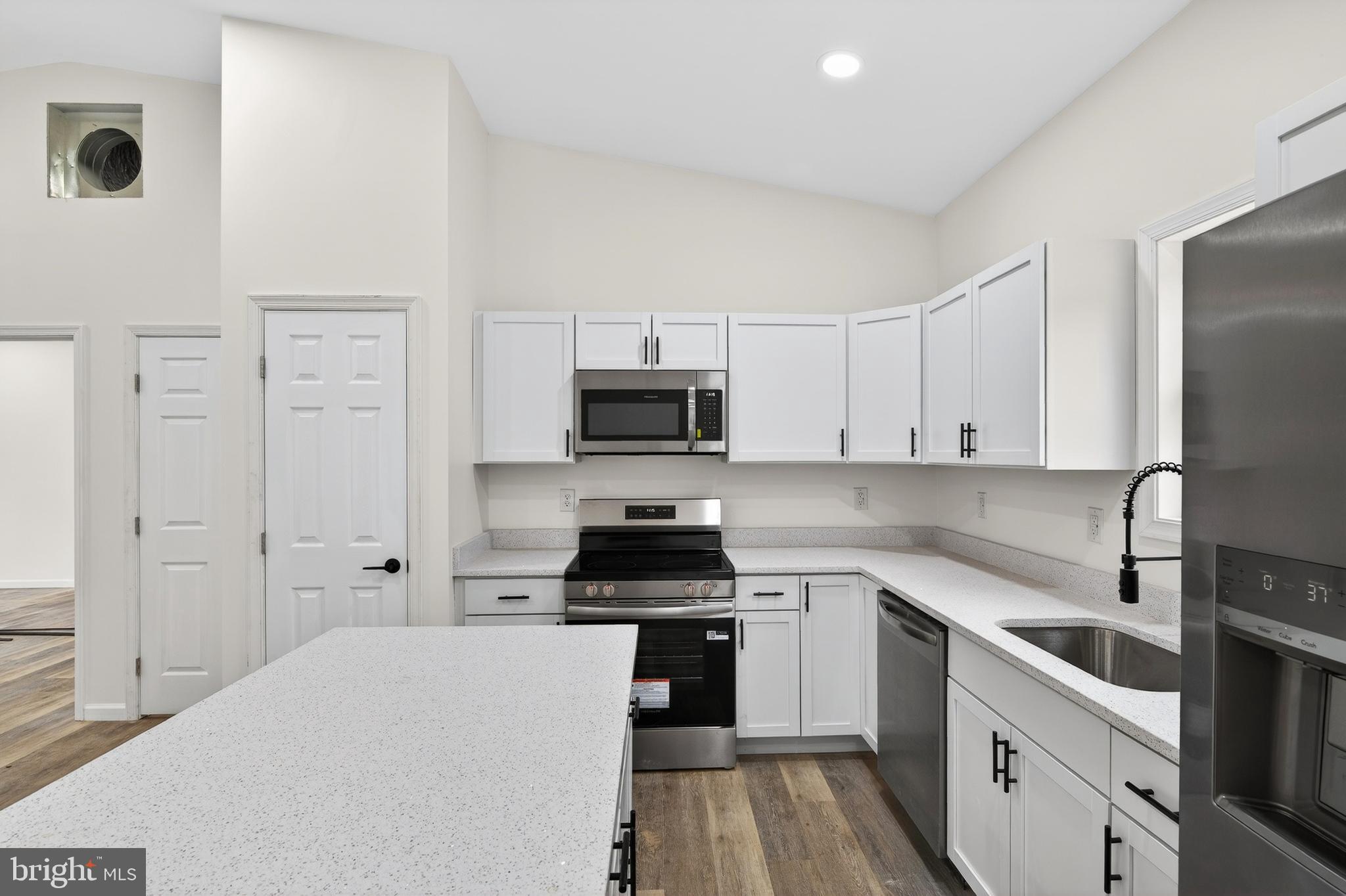 875 Buffalo Rdg Road Augusta, WV 26704 - Photo 5 of 27 a kitchen with white cabinets and stainless steel appliances