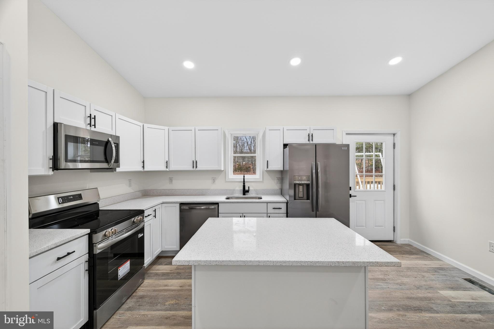 875 Buffalo Rdg Road Augusta, WV 26704 - Photo 6 of 27 a kitchen with a sink a counter top space stainless steel appliances and cabinets