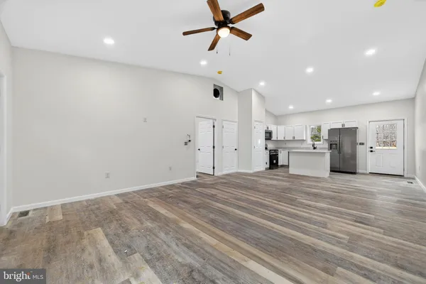 a view of kitchen and empty room