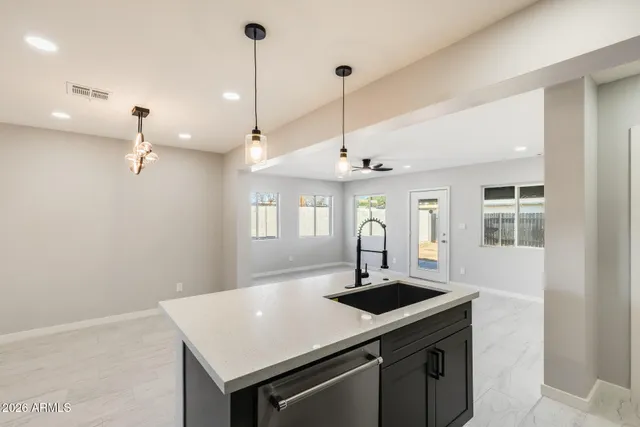 a view of a kitchen with a sink a counter space and a window