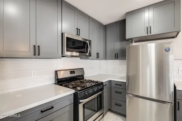 a kitchen with a refrigerator stove and microwave