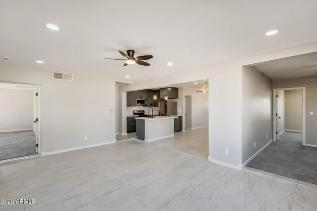 a view of a kitchen with a sink and a refrigerator
