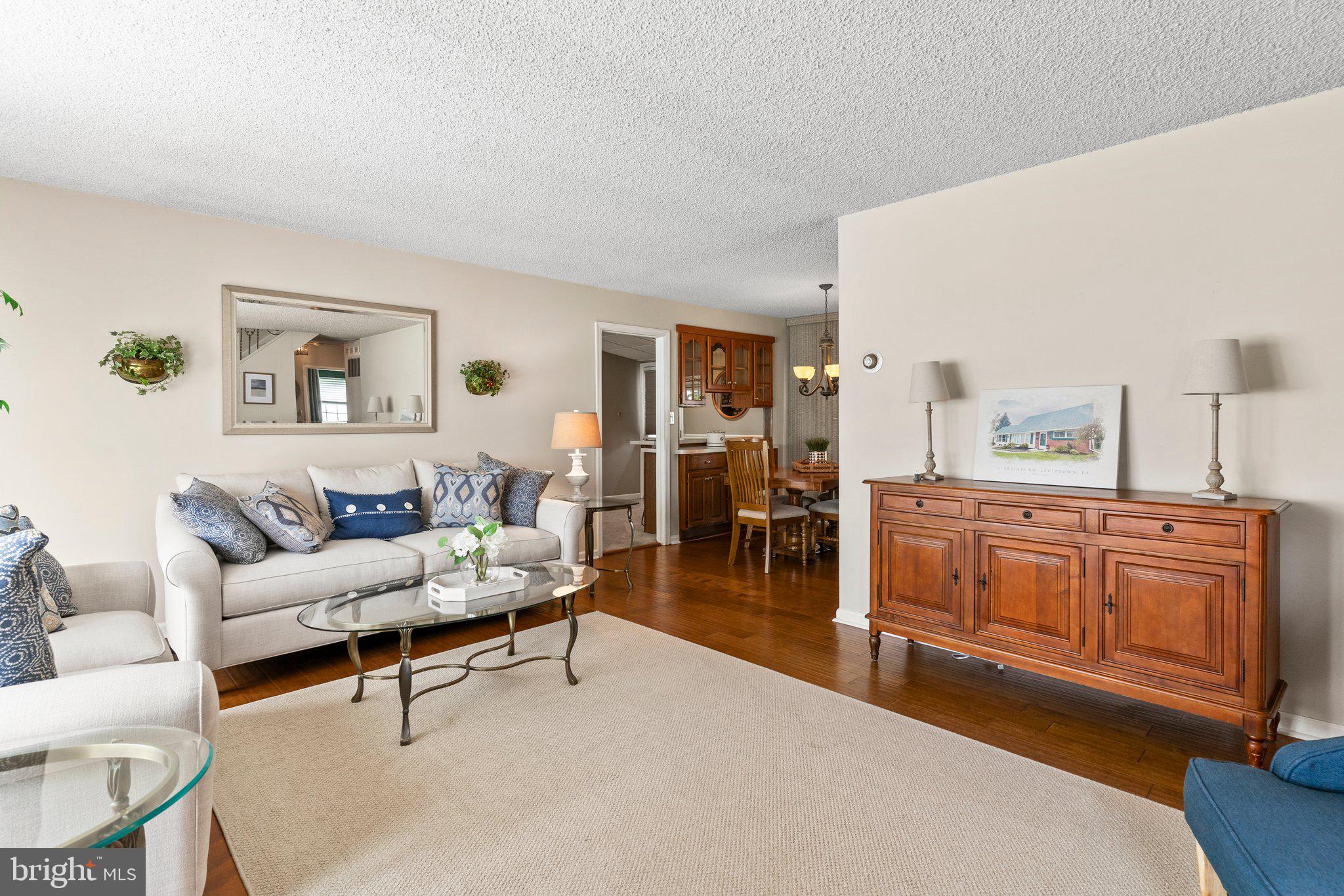 11 Trellis Road Levittown, PA 19056 - Photo 5 of 37 a living room with furniture a rug and kitchen view