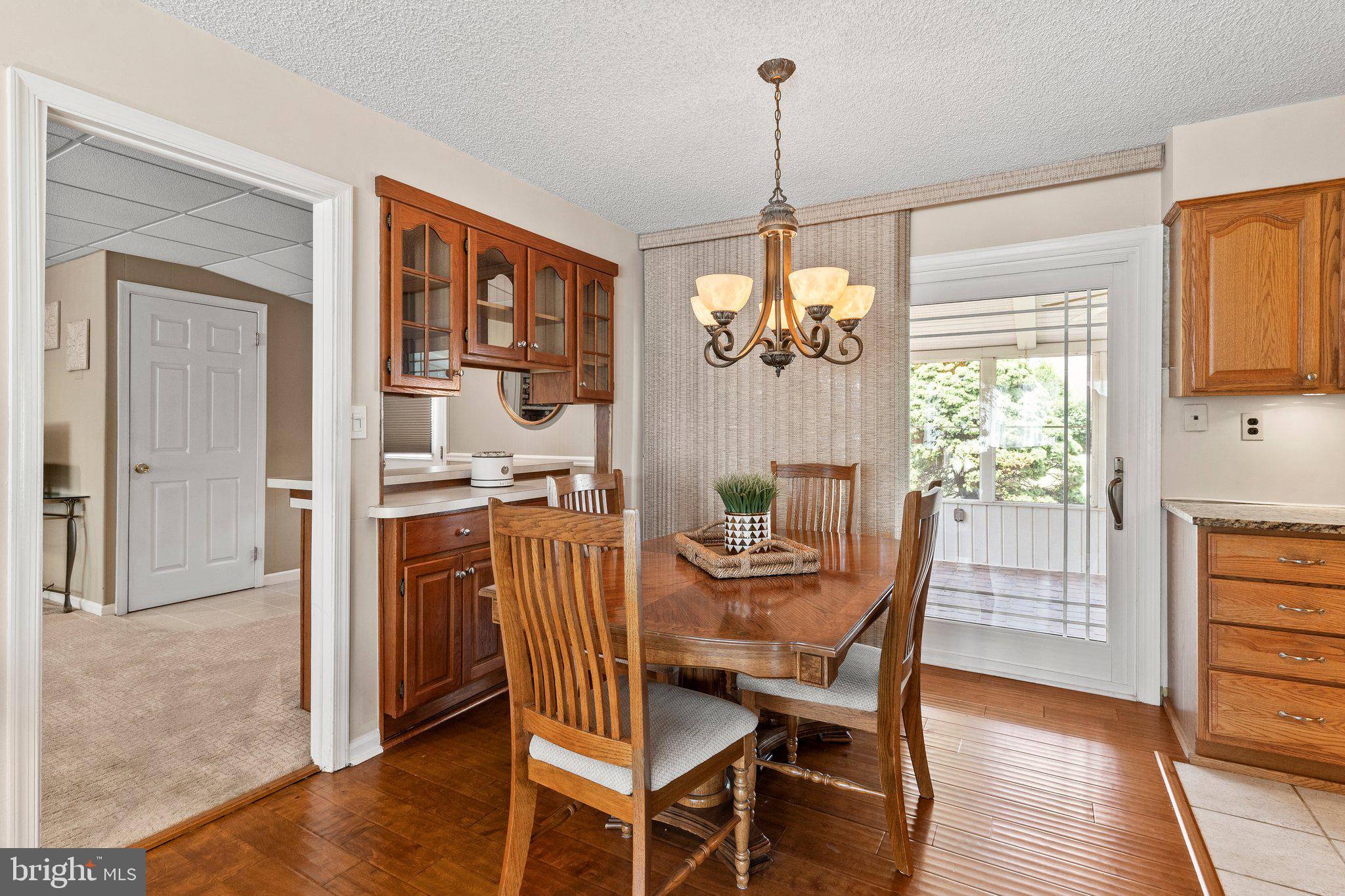 11 Trellis Road Levittown, PA 19056 - Photo 8 of 37 a dining room with furniture a chandelier and wooden floor