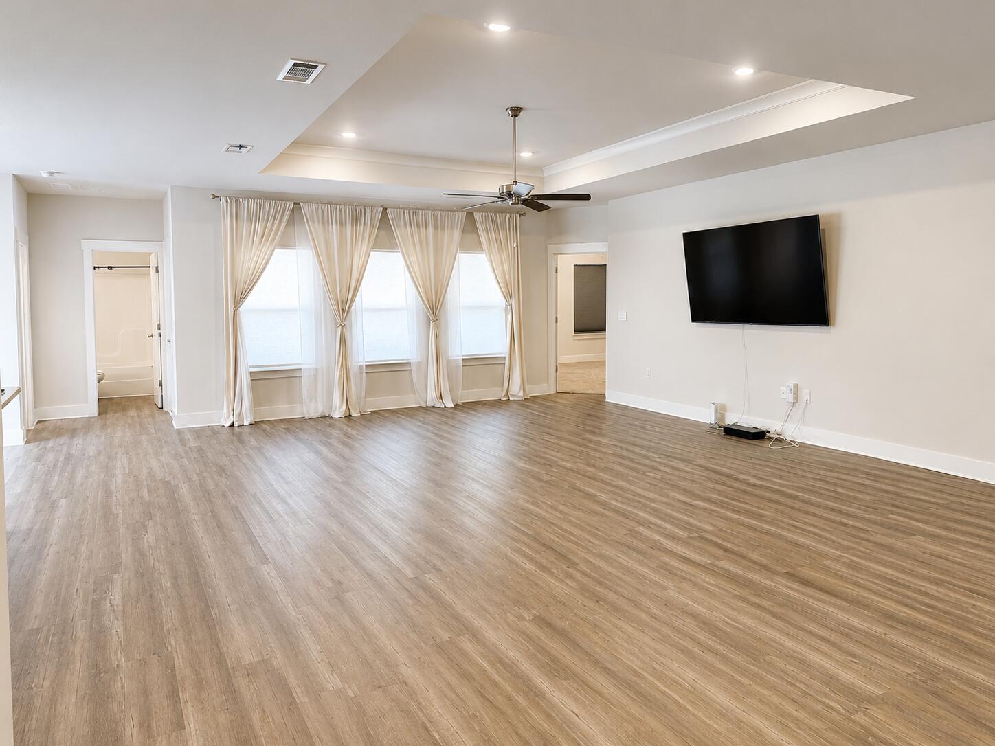 734 Quintana Street Crestview, FL 32539 - Photo 4 of 16 a view of a livingroom with wooden floor and a ceiling fan