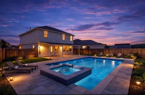 a swimming pool with outdoor seating and yard