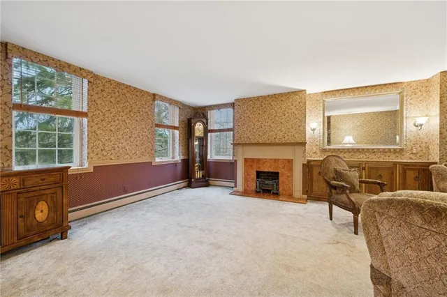 a living room with furniture and a fireplace