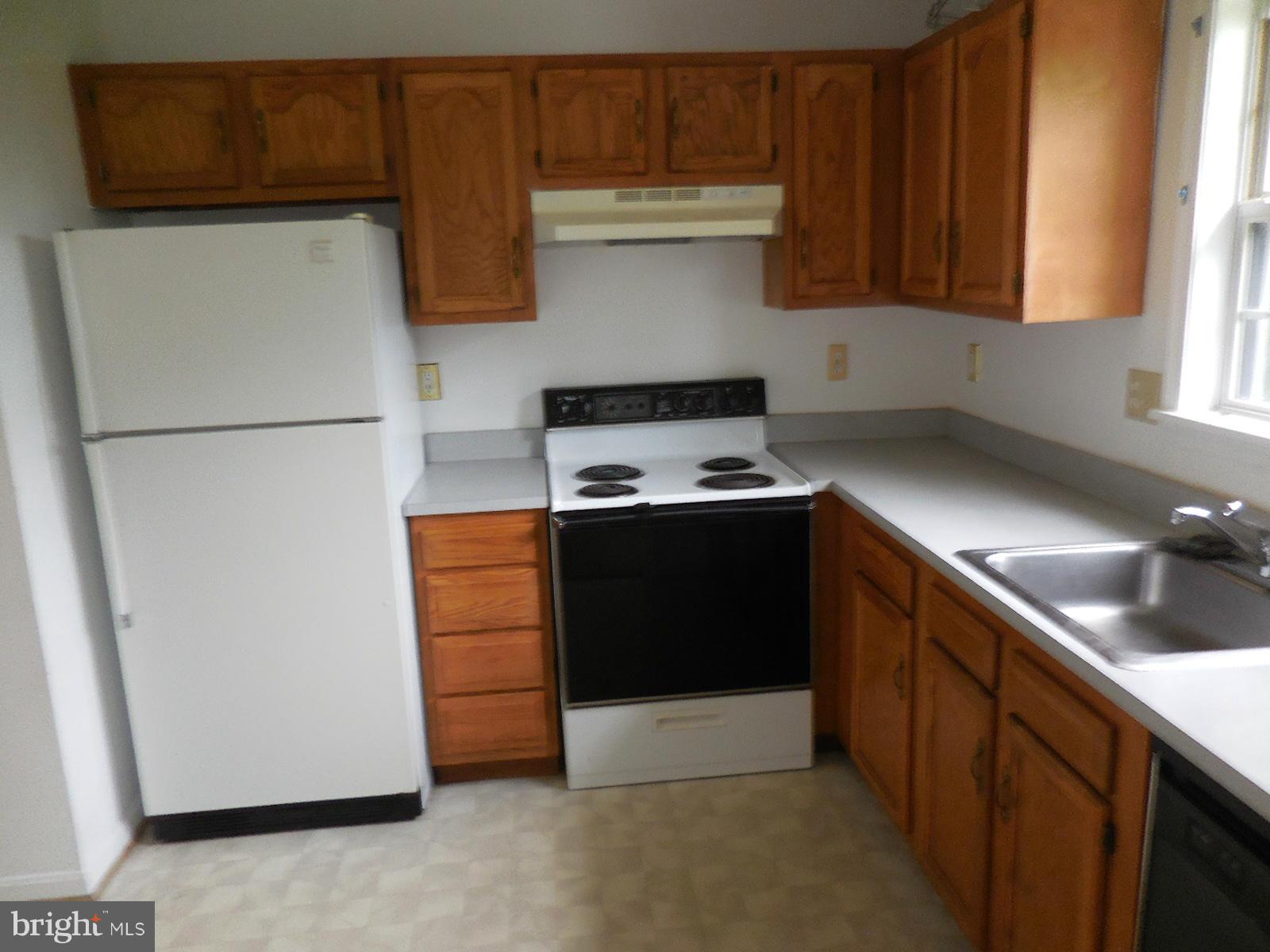 6322 Springbrook Lane Clinton, MD 20735 - Photo 4 of 9 a kitchen with a refrigerator and a sink