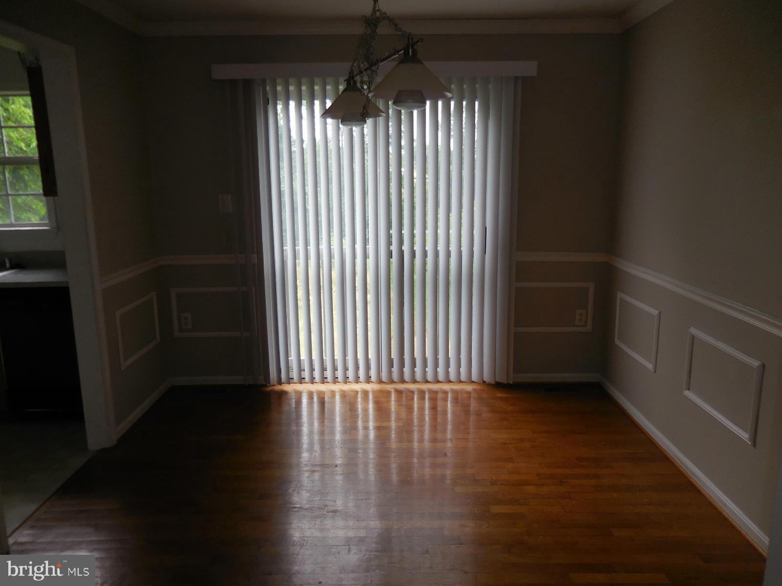 6322 Springbrook Lane Clinton, MD 20735 - Photo 5 of 9 a view of an empty room with wooden floor and a window